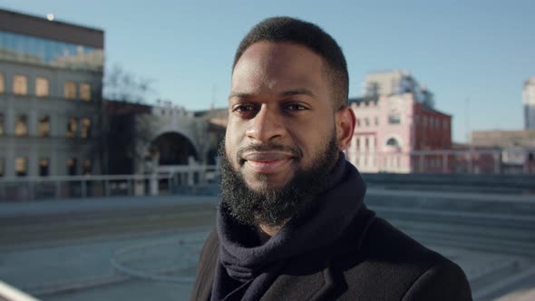 Outdoor Portrait of Serious Bearded African American Man in Coat Walking in Empty City Center