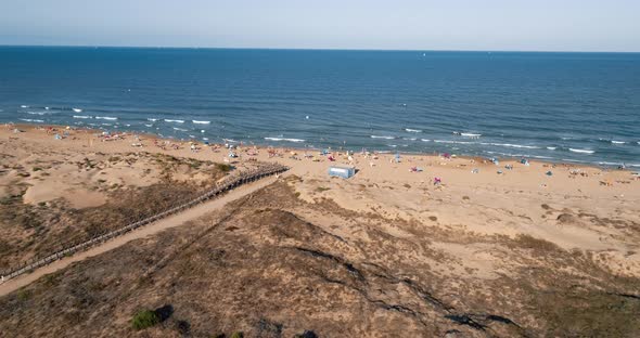 Drone Flies Over Dunes and Road Showing Wild Beach on Mediterranean Sea in Spain