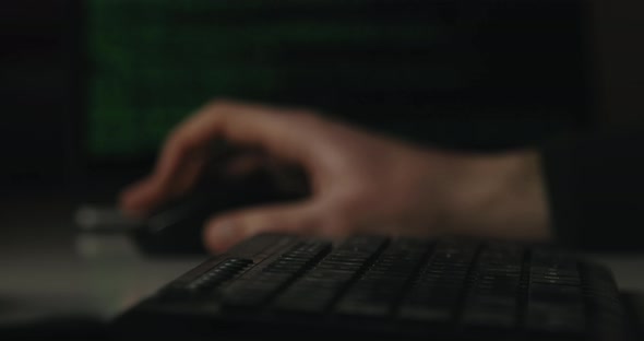 Hacker is Typing Keys on a Keyboard in His Room