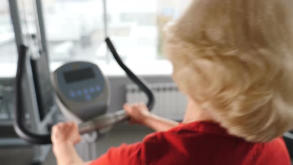 Backview on Retired Woman in Gym Doing Cardio Exercise