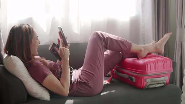 Woman happy selfie portrait with her passport and credit card before travel trip