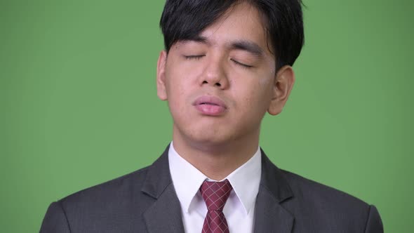 Young Handsome Asian Businessman Looking Bored