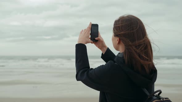 Woman's Girl Female Tourist Hand Holding Smart Phone Mobile Smart Phone Over Blurred Beautiful Blue