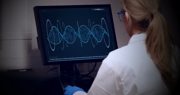 Doctor looking dna molecule on computer