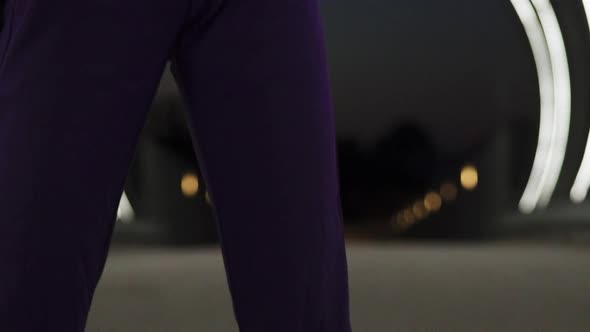 Teenage Model Posing While Standing in the Middle of Open Light Tunnel at Night