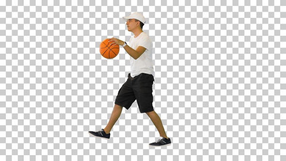 Young casual man bouncing basketball ball, Alpha Channel