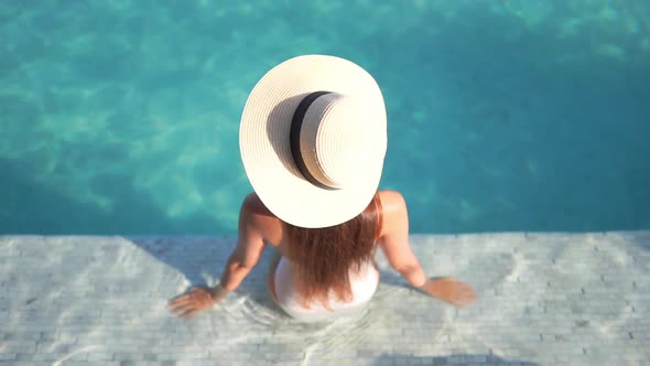 Young asian woman enjoy around outdoor swimming pool for leisure