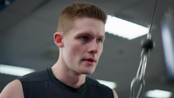 Closeup Portrait of Concentrated Handsome Sportsman Training in Gym