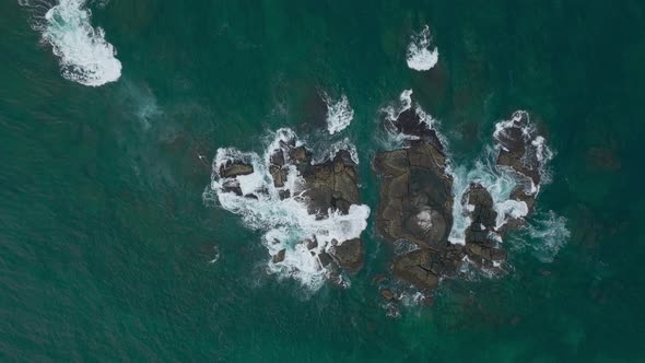 Waves Crash Against Rocks in the Ocean