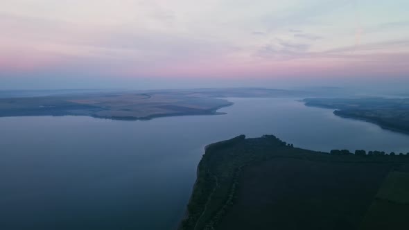 Aerial drone view of the Duruitoarea natural reservation in Moldova. River and fog in the air, hills