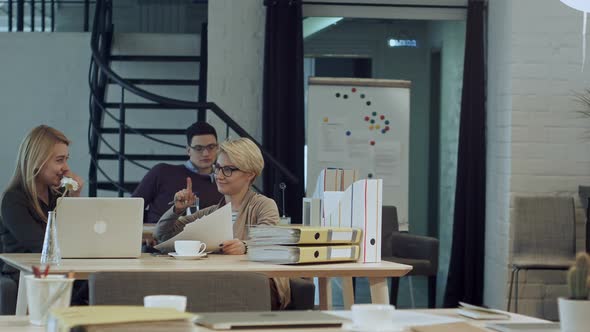 Two Women Having Coffee Break Together in Office