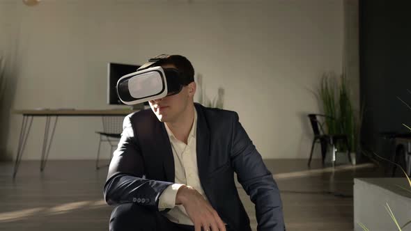 Portrait of a businessman in VR glasses in a stylish office