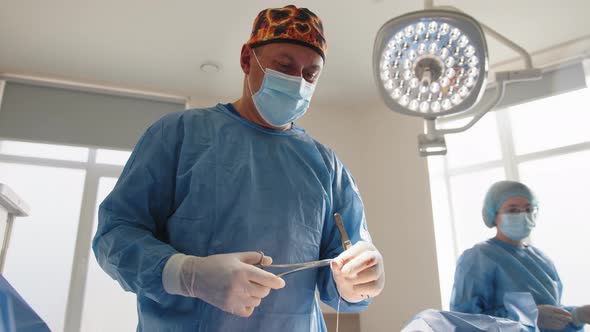 The Surgeon Uses a Needle Holder to Hold the Surgical Needle and Thread to