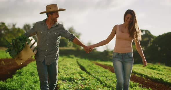 Happy couple holding hands on farm