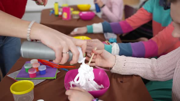 Female Hand Adding Shaving Foam for Making Slimes