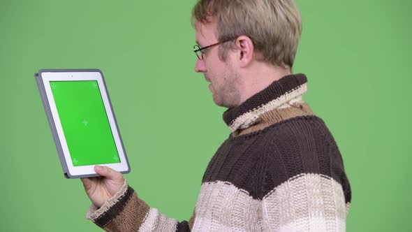 Profile View of Happy Handsome Man Using Digital Tablet