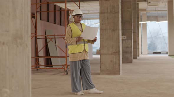 Architect Checking Work Progress in Building