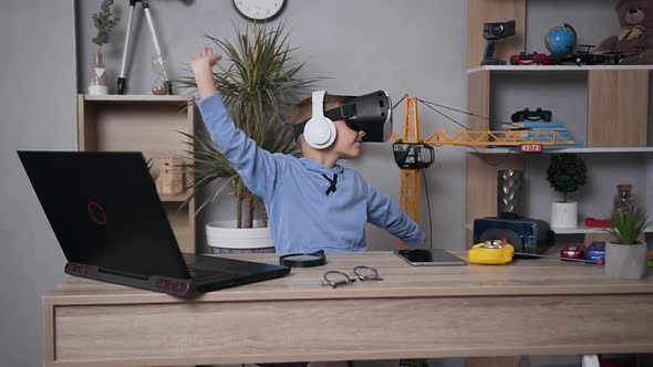 Cool Joyful Modern 7-Aged Boy Dancing at Home Using Virtual Reality Headset