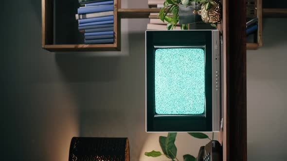 Vertical Video of Old Television with Grey Interference Screen on Home Background