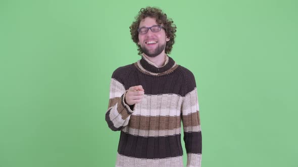 Happy Young Bearded Man Laughing and Pointing at Camera