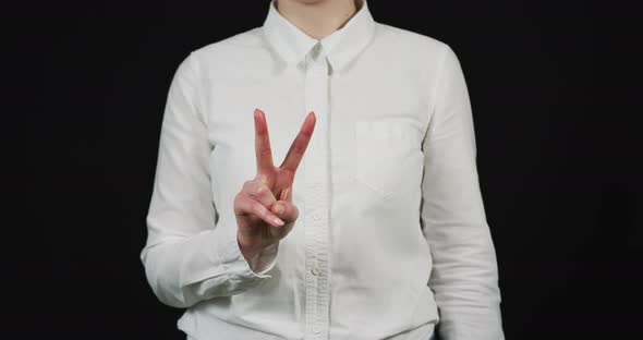 Hand of a woman showing victory sign