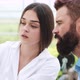 Woman and Man in Laboratory Robes Examine Carefully Plants in the Greenhouse - VideoHive Item for Sale
