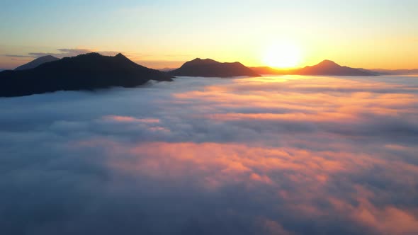 4K Aerial view flying in fog. clouds at sunset fog.