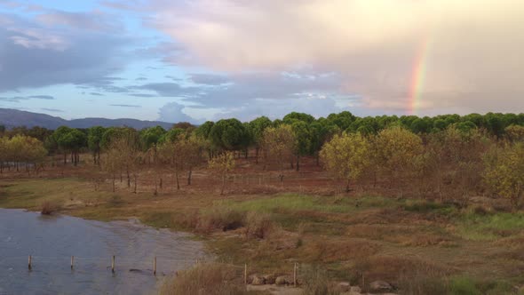 Lake drone aerial view of mountain panorama landscape at sunset with rainbow in Marateca Dam in Cast