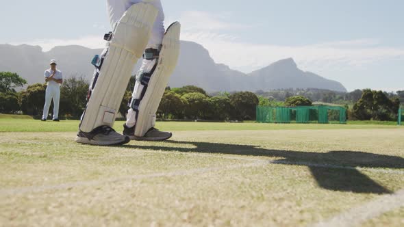 Cricket player stopping the ball in a pitch