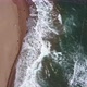 aerial view of waves and empty lounge in the morning. empty beach and deck chairs. - VideoHive Item for Sale