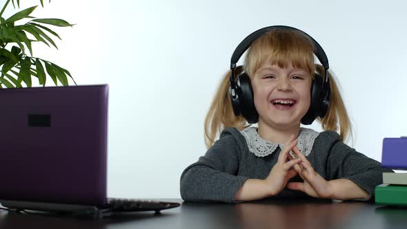 Child Schoolgirl Kid Laughing and Smiling, Learning Lessons at Home and Using Laptop Computer