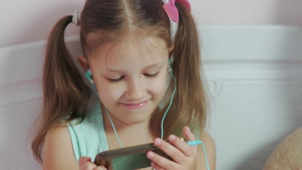 Little Girl At Home Bedroom On Bed Communicating