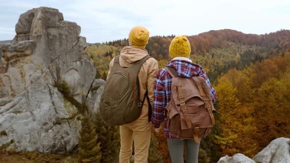 Rear View Couple Tourists Stands on Autumn Landscape Background with Cliffs in National Park Tustan
