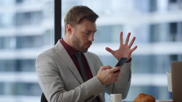 Professional Man Celebrate Victory Using Phone Reading Good News in Cafe Office