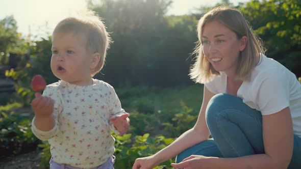 Mother smiles and communicates with the child.