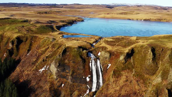 Aerial Panoramic Landscape of Waterfall Flowing From the Blue Lake in Iceland