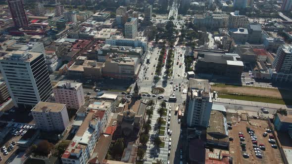 Aerial dolly in of Vergara Square, traffic in Libertad Avenue and Viña del Mar neighborhood city bui