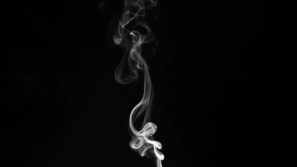 swirling smoke, smoke slowly rising against a black background