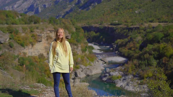 A Handheld Shot of a Young Woman That is Visiting the Moracica River Canyon in Montenegro