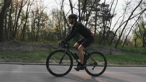 Cycling on bicycle in park at sunset