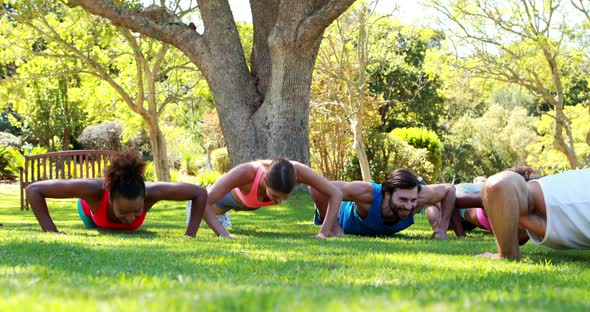 Group of friends doing push ups