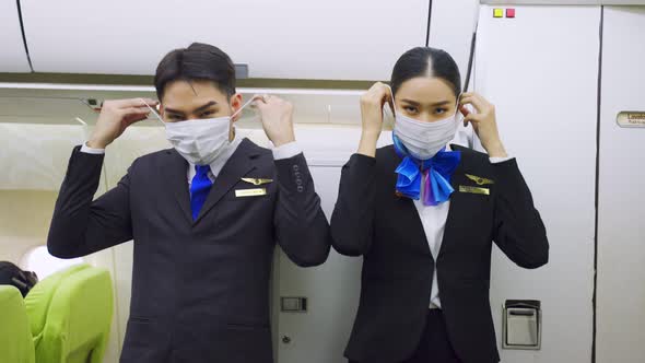 Portrait of Cabin crew flight attendant and Airliner pilot wear face mask to prevent COVID pandemic.