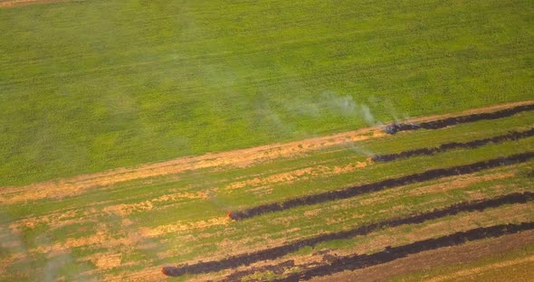 View From Above on the Fire on Field in Countryside