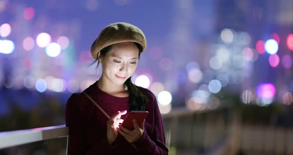 Young woman use of mobile phone in the street