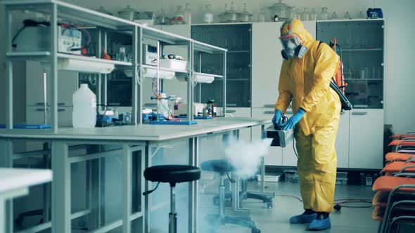 A Man in a Hazmat Suit Is Sanitizing a Laboratory Classroom During COVID-19 Outbreak.