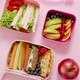 Shot of School Lunchboxes with Various Healthy Nutritious Meals on Pink Background - VideoHive Item for Sale