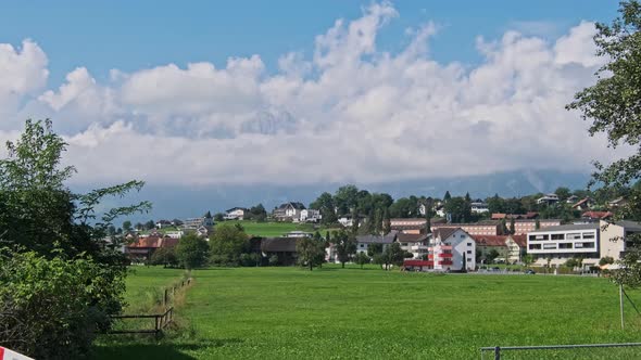 Panoramic View Liechtenstein with Houses on Green Fields in Alps Mountain Valley