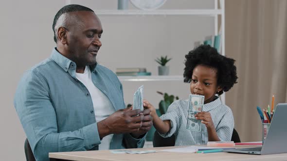 African American Family Sitting at Desk Adult Father Home Teacher Teaches Financial Literacy