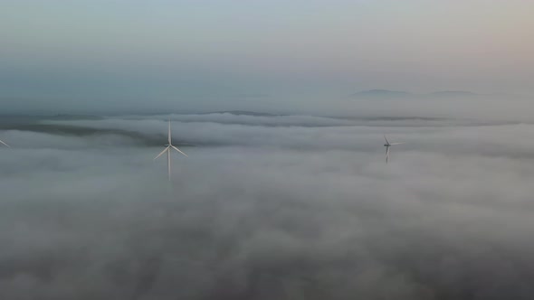 Fog Rolling in at Wind Power Turbines at the Irish Coast at Portnoo County Donegal  Ireland