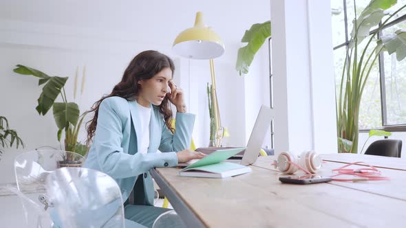 Woman Working at Home with a Laptop